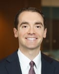 Andrew Bosserman, founder of Boss Tax Law, professional headshot in navy suit and patterned tie